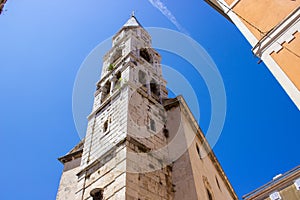 Picture of the Bell Tower of St. Elias` Church or Church of St. Elias in the old town of Zadar, Croatia, with a vapur trail in