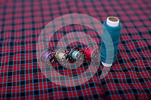 Picture of blue sewing thread and bobbins on the cloth