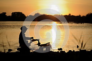 A picture of a boy`s silhouette under the sun.