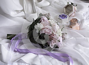 Picture of bridal bouquet. Married couple ceremony wedding day. Newly wed couple's hands with wedding rings.