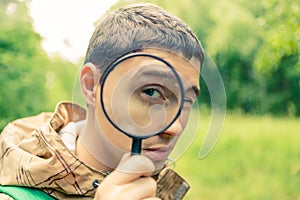 Picture of brunet biologist with magnifying glass