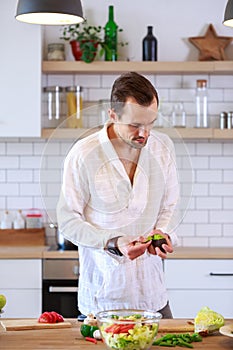 Picture of brunet cooking dinner on table