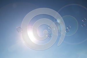 Bubbles floating in a blue sky in the summer