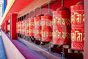 Picture of buddhist prayer wheels in a row