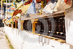 Picture of buddhist prayer wheels in a row