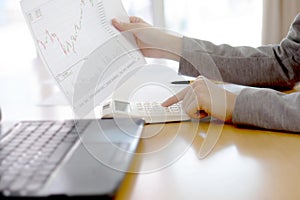 Picture of businesswoman with financial report at office