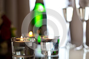 Picture of champagne with candles on the bedside table