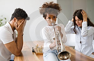 Picture of child making noise by playing trumpet