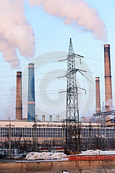 Picture of a cogeneration plant blowing smoke out of its chimneys