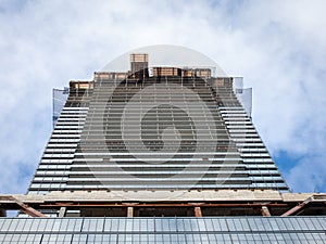 Cranes and building devices on a construction site of a skyscraper in downtown Toronto, surrounded by other high rise towers