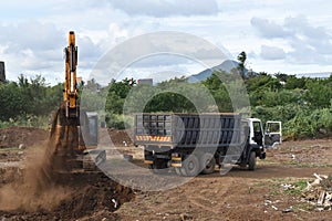 Picture of earthwork activity, digging operation ongoing with a truck awaiting to be loaded.