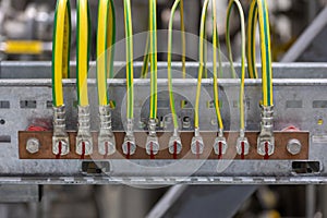 Picture of electrical grounding on a copper rail in a industrial area