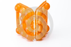 Picture of Empty Obsolete Orange Egg Hiolder. Placed Against White Background