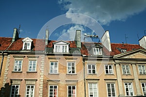 Typical Medieval Facade of an old appartment residential building in a street of old town, the historical center of Warsaw, Poland photo
