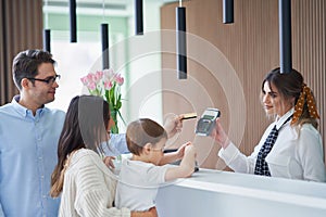 Picture of family checking in hotel