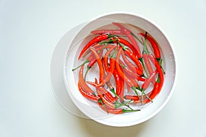 Red chili peppers in a white bowl photo