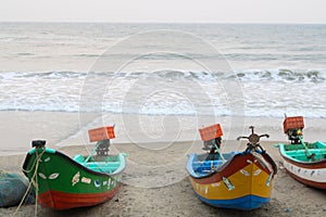 This is a picture of fishing boats parked near the seashore