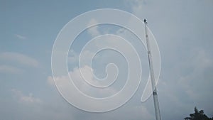 A picture of flag pole or tiang bendera with sky as background photo