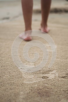 Footprint indents in sand at the beach