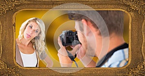 Picture frame and caucasian man photographing young woman sticking out tongue with camera