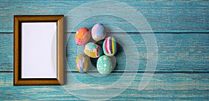 Picture frame and colorful easter eggs. Easter festive holidays concept