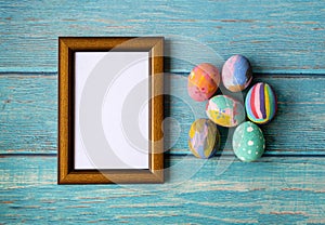 Picture frame and colorful easter eggs. Easter festive holidays concept