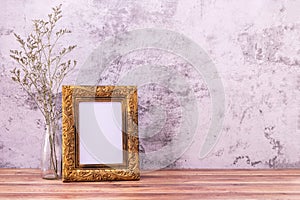 Picture frame with flowers on wall background and wooden table. Poster product design styled