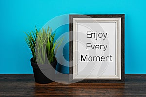 Picture frame with inspirational text Enjoy every moment