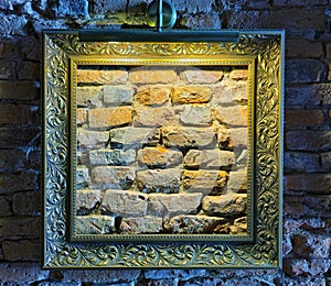 Picture frame on an old wall in lowlight