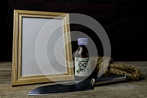 Picture frame and poison and knife. photo