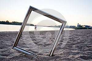 Picture frame in the sand, on the beach in summer photo