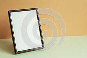 Picture frame on table. orange background