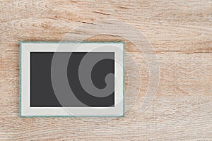 Picture frame on wooden texture background