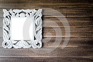 Picture frame on wooden wall.