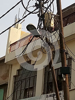 This picture of Ghaziabad vegetable market is of electric pole where many laborers are working, countless wire mesh is made