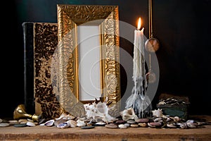 Picture gold frame and candle .