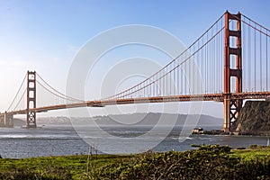 Picture of the Golden Gate Bridge in San Francisco crossing the bay of the Californian city under a blue sky.