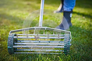 Picture of grass aerator on the green lawn