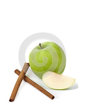 Picture of green apple and sticks of cinnamon on the white back