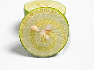 Picture of green citrus with leafs on a white isolated background