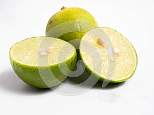 Picture of green citrus with leafs on a white isolated background