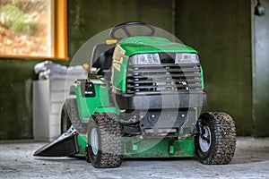 Picture of green lawn mower in the garage