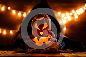 Picture of halloween pumpkin cut in shape of face with witch