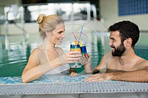 Picture of happy couple relaxing in pool