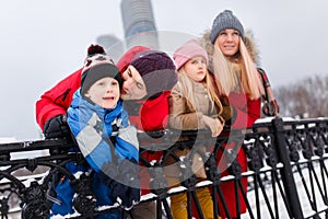 Picture of happy parents with daughter and son on winter walk