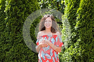 Picture of happy pregnant woman posing isolated over grey wall. Looking at camera and pointing