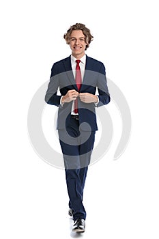 Picture of happy young businessman unbuttoning and opening suit