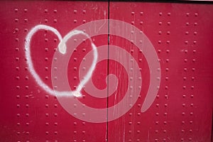 A picture of a heart graffiti on red background