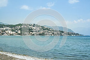 Picture of Herceg Novi, Montenegro,  seen from a beach on the adriatic sea on the foreground.