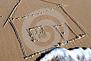 Picture of a house drawn in the sand